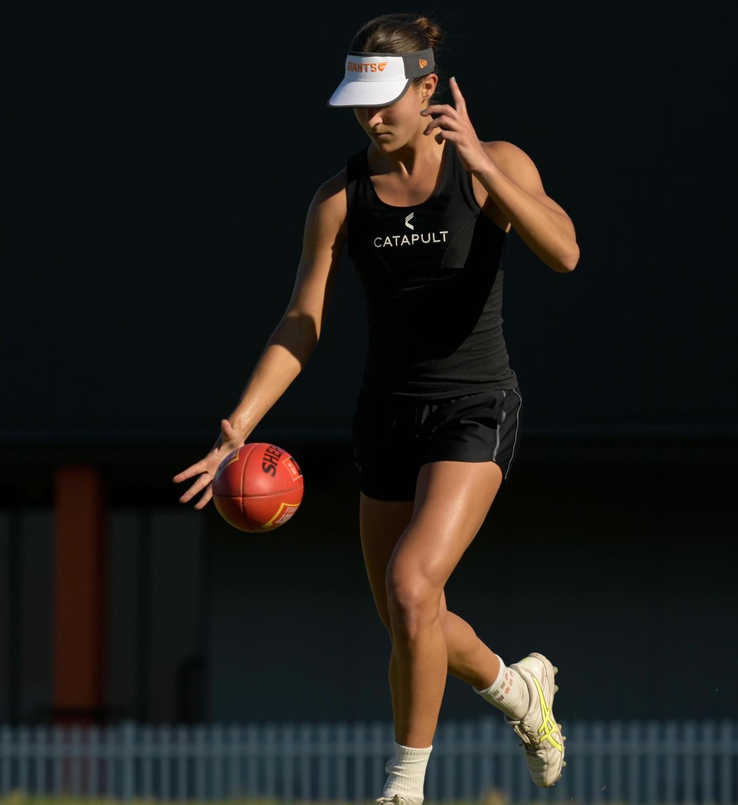 Yas mid-stride, dropping the ball to boot.