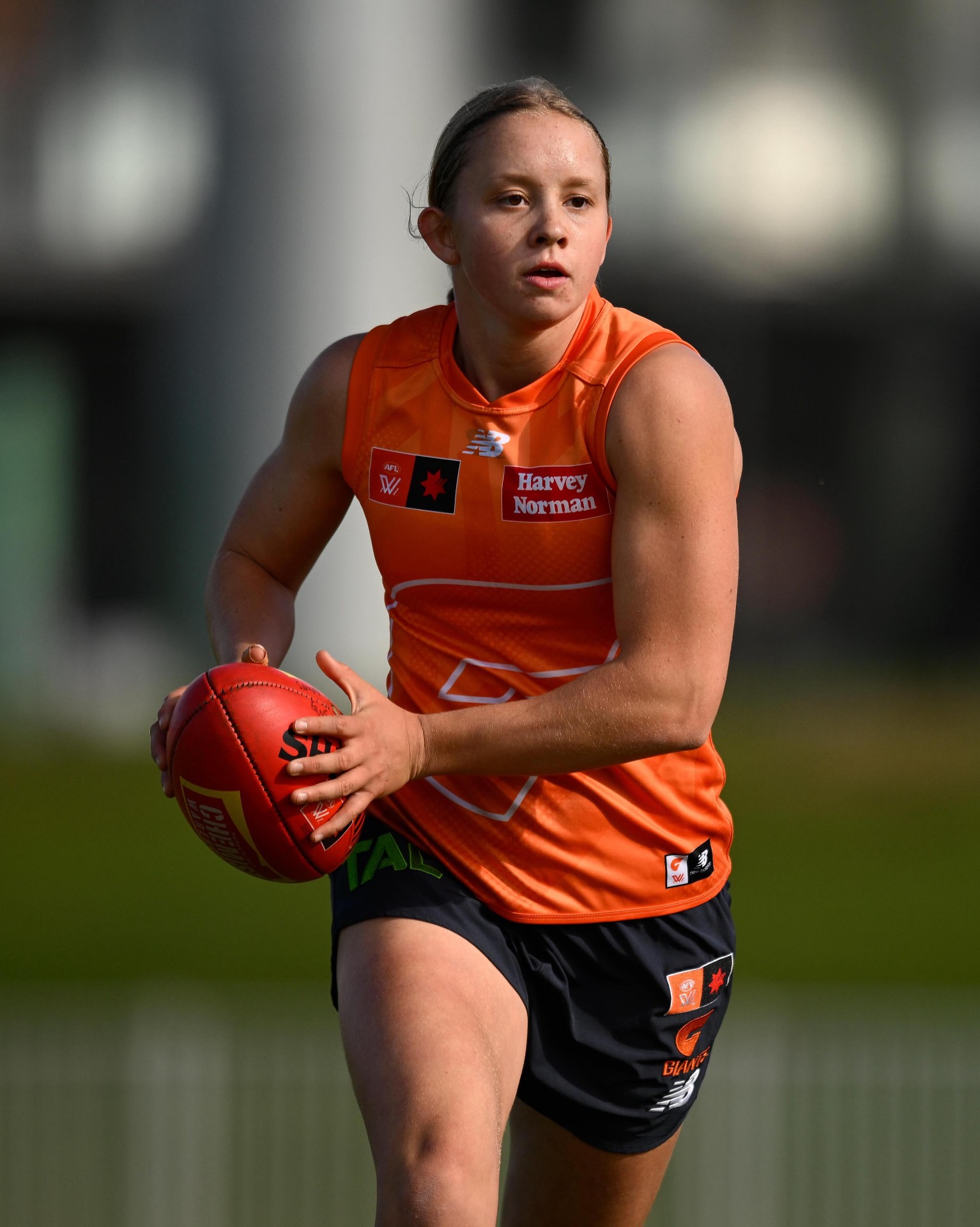 Soph running with ball in hand, mid-stride.